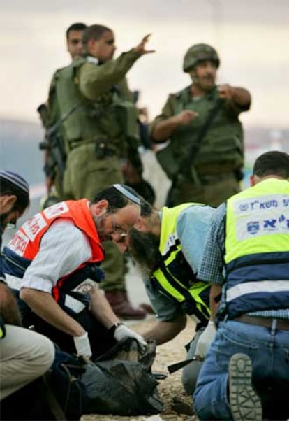 Personal sanitario israelí recoge los restos de las víctimas del ataque.