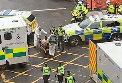 Varias personas han sido acuchilladas este viernes en un hotel del centro de Glasgow por un hombre que fue abatido por la policía. En la imagen, los servicios de emergencia trasladan a un herido hacia a una ambulancia.