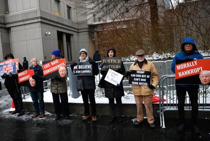Protesters stand outside of the Federal court holding signs before the start of the second Civil Defamation Trial against former US president Donald J. Trump brought by journalist E. Jean Carroll in New York, New York, USA, 16 January 2024