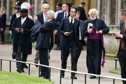 Nick Cave, center, arrives ahead of the coronation ceremony of King Charles III  at Westminster Abbey.