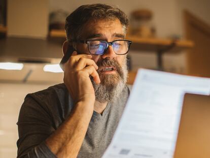 Mature men at home during pandemic isolation reading something on laptop