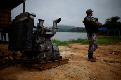 An officer of National Public Security in Brazil stands in addition to a gold extraction pump engine on the indigenous country of Munduruku in the state of Pará, Brazil, last November.