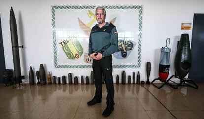 Lieutenant Salvador Serrano stands in front of projectiles used during the Civil War.