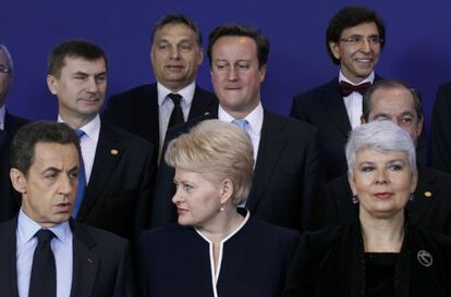 David Cameron (centro) mira a Nicolas Sarkozy durante la foto de familia de la cumbre europea.