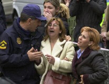 Un agente de polica trataba de consolar ayer a algunos de los familiares de los obreros sepultados por el drrumbamiento.