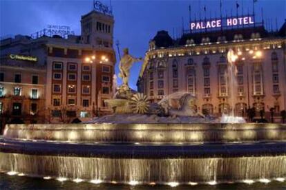 La plaza de Neptuno iluminada, con el hotel Palace al fondo.