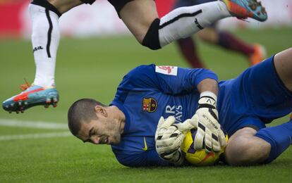 Víctor Valdés atrapa un balón.