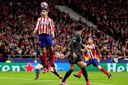 El delantero del Atlético de Madrid Álvaro Morata (izquierda) intenta un remate ante el Liverpool, en partido de ida de octavos de final de la Liga de Campeones que se disputa este martes en el estadio Wanda Metropolitano.