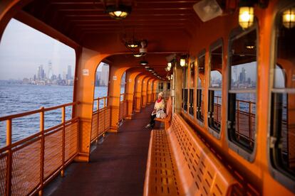 A commuter enjoys the sunset alone on the upper deck of a Staten Island Ferry during the outbreak of the coronavirus disease (COVID-19) in Manhattan, New York City, U.S., March 26, 2020.