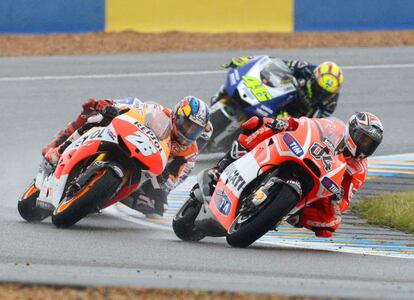 Dani Pedrosa of the Repsol Honda Team, Italian riders Valentino Rossi (back) of the Yamaha Factory Racing team and Andrea Dovizioso of the Ducati Team in action during the Motorcycling Grand Prix of France.