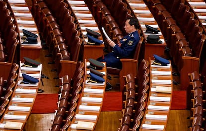 Un miembro de la delegación militar lee antes de la sesión inaugural del Congreso Nacional del Pueblo en el Gran Salón del Pueblo en Pekín, China, este martes.

