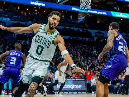 Boston Celtics forward Jayson Tatum (0) celebrates after a dunk against the Charlotte Hornets during the second half of an NBA basketball game on Saturday, Jan. 14, 2023, in Charlotte, N.C.