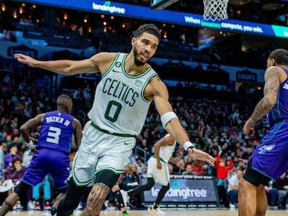 Boston Celtics forward Jayson Tatum (0) celebrates after a dunk against the Charlotte Hornets during the second half of an NBA basketball game on Saturday, Jan. 14, 2023, in Charlotte, N.C.