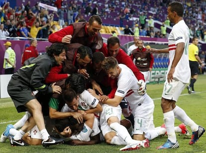 Portugal&#039;s players celebrate their late winner over Denmark in Lviv.