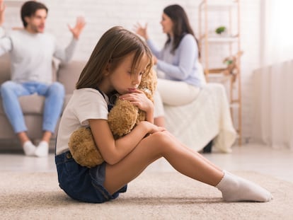 Family Problems. Cute Little Girl Suffering From Parents Arguing, Sitting On Floor With Teddy Bear, Feeling Abandonned And Lonely