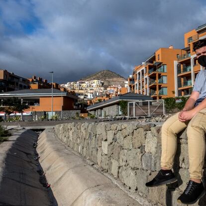 Yassine El Assire, de 23 años, posa con sus pertenencias en la calle frente al hotel Arguineguín Park, Gran Canaria, donde le fue negada la entrada tras ausentarse varios días para intentar viajar a la Península.