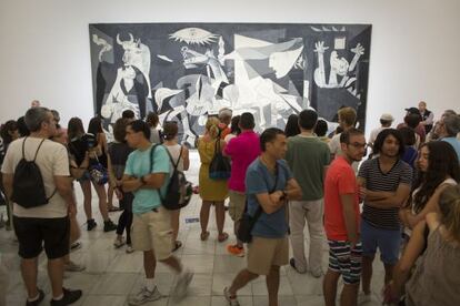 Visitors milling in front of Picasso's famous mural 'Guernica', at Reina Sofía