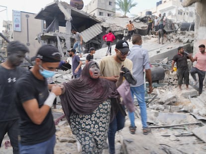 An injured woman is evacuated after an Israeli bombardment on Deir al Balah, in the Gaza Strip, on October 22.