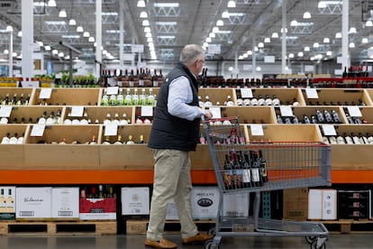 A customer looks at alcohol beverages while shopping at a Costco Wholesale store in Washington, DC, USA, 10 January 2024.