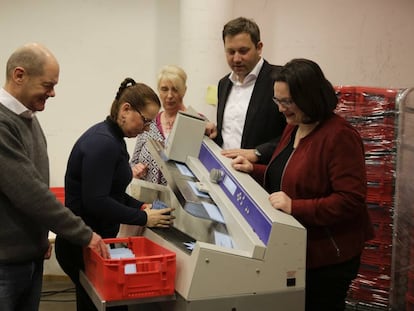 El líder del SPD y alcalde de Hamburgo, Olaf Scholz (izq.), y la líder del partido en el Bundestag, Andrea Nahles (dch.),  durante el recuento de votos en el referéndum sobre la gran coalición celebrado entre las bases. (AP Photo/Markus Schreiber)