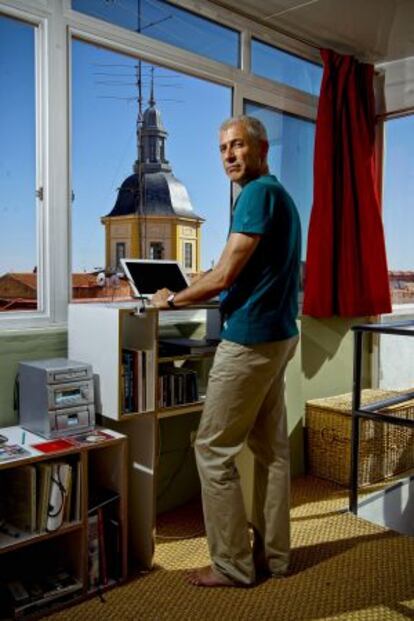 José Ovejero standing at his computer at his home in Madrid.