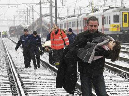 Un pasajero saca a una niña de uno de los dos trenes accidentados en Buizingen, una pequeña localidad situada a unos 20 kilómetros de Bruselas.