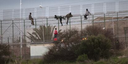 Cruz Roja ayuda a cuatro subsaharianos, en la valla de Melilla.