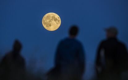 Algunes persones veient la lluna plena a Berlín, Alemanya, abans de l'eclipsi.