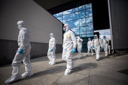 Members of the Emergency Military Unit disinfect a train station in Granada.