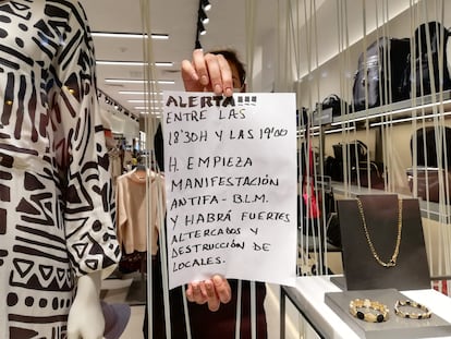 Andrea Pascual, who works at the Parfois store in Puerta del Sol, shows a sign she was given by a stranger ahead of the protests. 