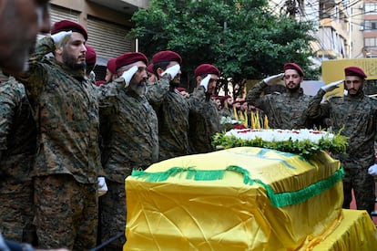 Hezbollah militiamen stand at attention over the coffins of Ibrahim Akil and Mahmoud Hamad, senior commanders who were killed in an Israeli airstrike in Beirut on Sunday.