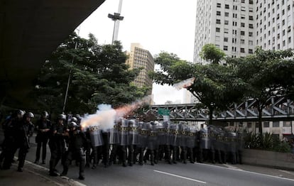 Policial dispara bomba de gás contra manifestantes.