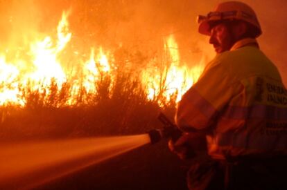 Un bombero trata de apagar el fuego declarado anoche en la Serra d'Irta en Castellón.