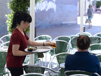 Una camarera sirve una cerveza en una terraza de Valladolid.