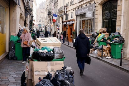 A man walks past uncollected garbages in Paris, Wednesday, March 15, 2023 as sanitation workers are on strike. Opponents of French President Emmanuel Macron's pension plan are staging a new round of strikes and protests as a joint committee of senators and lower-house lawmakers examines the contested bill. 