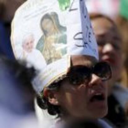 A woman looks on as Pope Francis celebrates a Mass before a crowd of hundreds of thousands in Ecatepec, Mexico