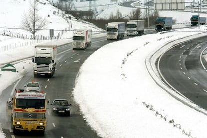 Varios camiones que quedaron atrapados por la nieve circulan por la A-67, a la altura del puerto del Pozazal, tras ser abierta.