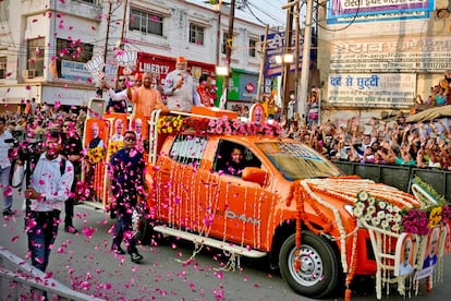 Indian Prime Minister Narendra Modi, center, and Uttar Pradesh Chief Minister Yogi Adityanath ride in an open vehicle while campaigning for the Bharatiya Janata Party (BJP) in Ghaziabad, April 6, 2024.