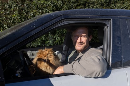 David, a resident of Pacific Palisades, waits with his dog Betty to be allowed through to check on his house, which he says has burnt down.