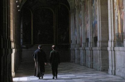 Dos monjes agustinos paseando por el claustro del monasterio de El Escorial.