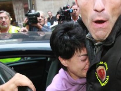 Rosario Porto is escorted to her apartment in Santiago by the authorities.