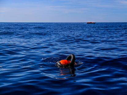 A body floats in the Mediterranean as a boat with Tunisian migrants heads to Lampedusa (Italy).