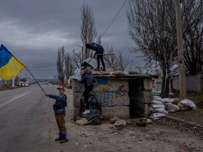 Ukrainian children play at an abandoned checkpoint in Kherson, southern Ukraine, Wednesday, Nov. 23, 2022. A new onslaught of Russian strikes on Ukrainian infrastructure on Wednesday caused power outages across the country — and in neighboring Moldova — further hobbling Ukraine's battered electricity network and compounding civilians' misery as winter advances. (AP Photo/Bernat Armangue)