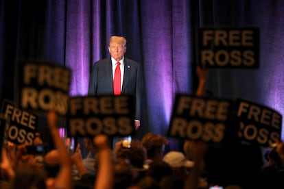 People hold signs in support of jailed darknet market Silk Road founder Ross Ulbricht, as former U.S. President and Republican presidential candidate Donald Trump attends the Libertarian Party's national convention in Washington, U.S., May 25, 2024. REUTERS/Brian Snyder