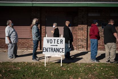 Voters wait in line outside a polling center on Election Day, Nov. 3, 2020, in Kenosha, Wis.