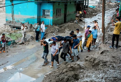 People carry a woman on a stretcher in an area affected by floods, in Teesta Bazaar, Kalimpong District, West Bengal, India October 7, 2023.