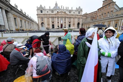 Los peregrinos se protegen de la lluvia.