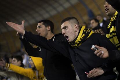 Beitar Jerusalem F.C. soccer supporters watch against Bnei Sakhnin at the Teddy Stadium in Jerusalem, Sunday, Feb. 10, 2013. Hundreds of police deployed around Beitar Jerusalem's stadium, two days after a suspicious fire believed to be set by angry fans destroyed the team's main offices. Tensions remained high Sunday as the team faced off with Bnei Sakhnin, an Arab team whose fans have clashed before with Beitar's. (AP Photo/Bernat Armangue)