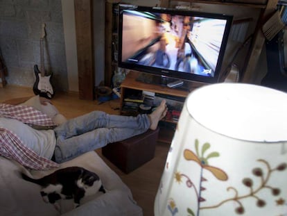 Un espectador dormido frente a la pantalla de televisión durante la emisión de un programa de máxima audiencia. 