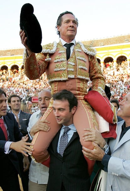 El diestro José María Manzanares, padre, a hombros del matador Enrique Ponce, durante la vuelta al ruedo que dio tras cortarse la coleta en La Maestranza de Sevilla, mayo de 2006.